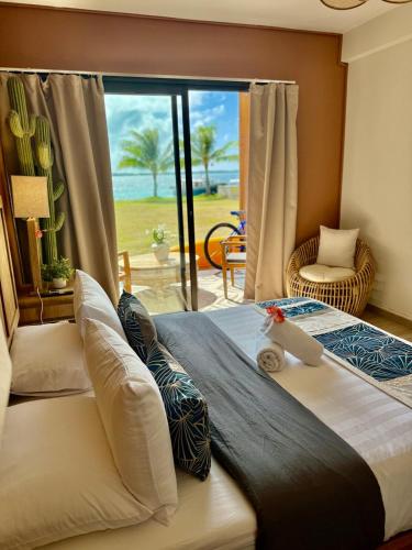 a bedroom with a large bed with a view of the ocean at Otemanu Lagoon Apartment with Lagoon View in Bora Bora