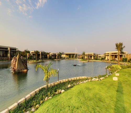 a body of water with houses and a resort at Araiya Gir,A Mavintara Resort in Chitrāwal