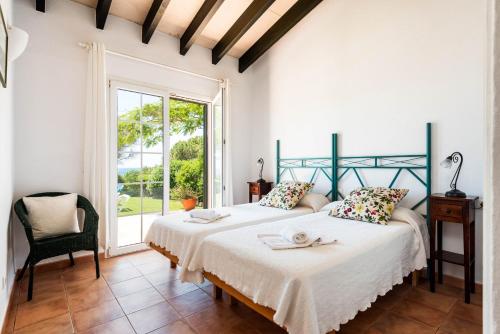 En eller flere senge i et værelse på Villa El Verano