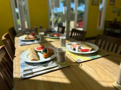 a wooden table with plates of food on it at Kenting COMIC B&B&SPRING in Hengchun