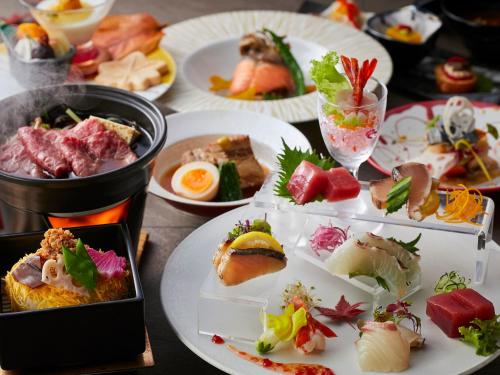 a table full of plates of food on a table at KAMENOI HOTEL Nara in Nara