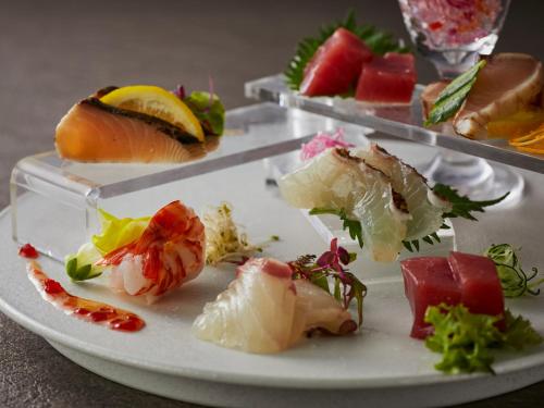 a plate of food with sushi on a table at KAMENOI HOTEL Nara in Nara