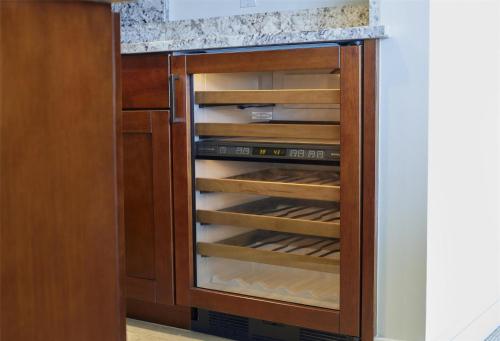 a kitchen with an empty wine cellar at Ka Laʻi Waikiki Beach, LXR Hotels & Resorts in Honolulu