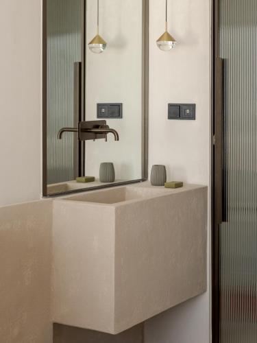 a bathroom with a sink and a mirror at Sifneos House in Naousa