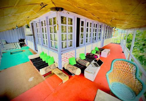 an aerial view of a house with chairs and tables at Shivaay homestay,cafe in Tosh