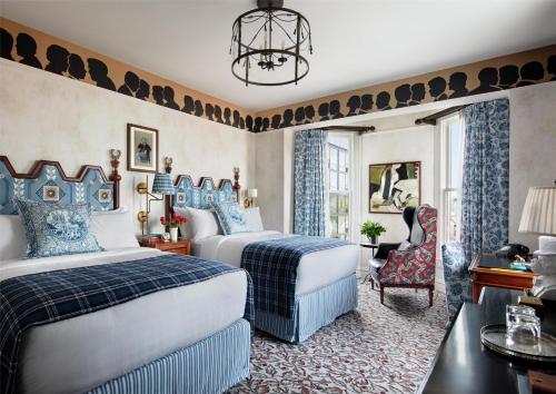 a hotel room with two beds and a chair at Graduate by Hilton New Haven in New Haven