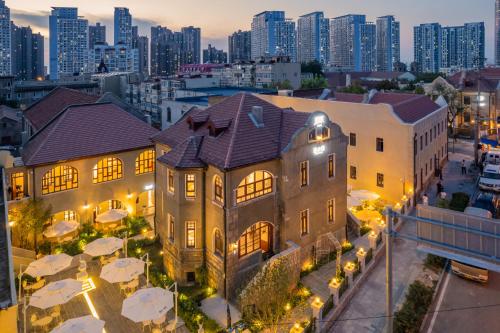 an aerial view of a building with a city skyline at TUIWA Garden Holiday Villa in Qingdao