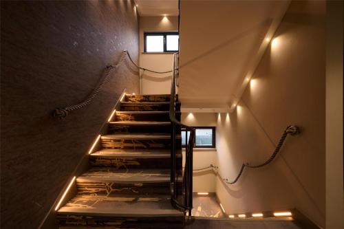 a set of stairs with lights in a building at Spark by Hilton Luton in Luton
