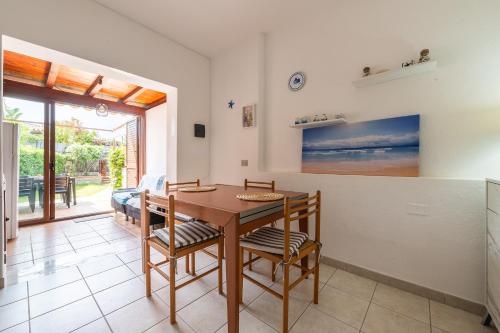 a kitchen and dining room with a table and chairs at Casa Nucci - Free WIFI - 100mt from the beach in San Stèfano