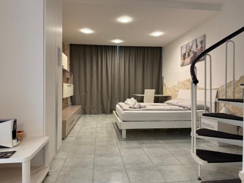 a bedroom with a bed and a room with a desk at Casa Vacanze Rosie in Cellamare