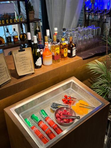 a bar with bottles of alcohol and a bowl of fruit at Sangju Hotel Seoul in Seoul