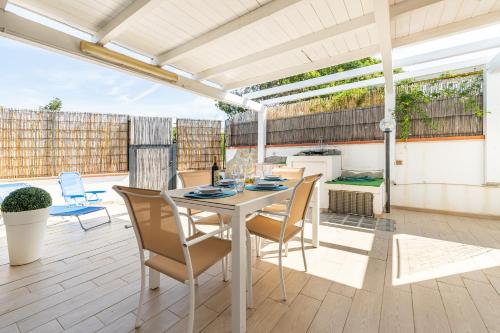 a patio with a table and chairs on a deck at Casa Nucci - Free WIFI - 100mt from the beach in San Stèfano
