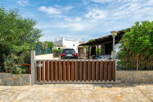 a wooden fence in front of a house at Casa Nucci - Free WIFI - 100mt from the beach in San Stèfano