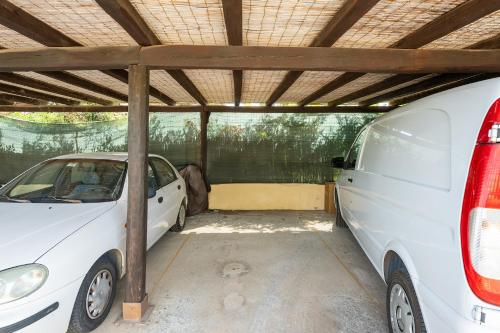a white car parked in a garage next to a van at Casa Nucci - Free WIFI - 100mt from the beach in San Stèfano