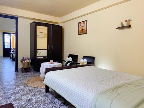 a bedroom with a large bed and a table at Daisy Homestay Hoian in Hoi An