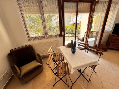 a living room with a table and a chair at Bliss Apartment Balatonfured in Balatonfüred