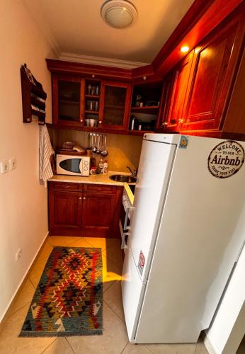 a kitchen with a refrigerator and a rug on the floor at Bliss Apartment Balatonfured in Balatonfüred