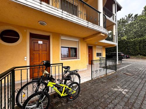 two bikes are parked outside of a building at Bliss Apartment Balatonfured in Balatonfüred