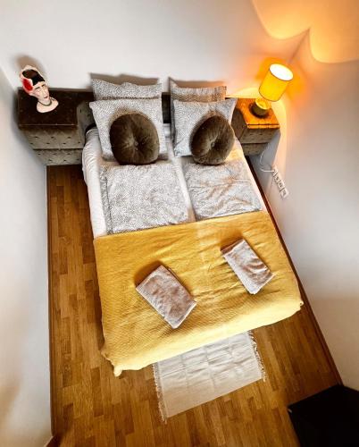 a bed with two cats sleeping on top of it at Bliss Apartment Balatonfured in Balatonfüred