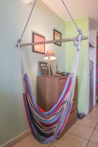 a hammock hanging in a living room at KETYA Duplex Mabouya OU Studio Hamac in Le Gosier