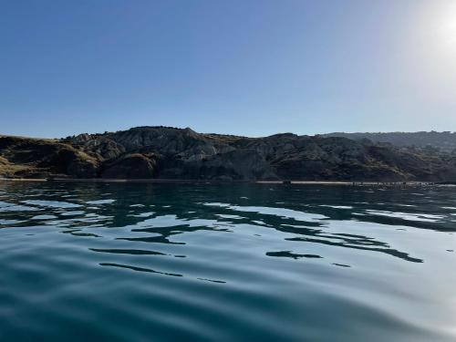 a view of a body of water with mountains in the background at Daedalium in Marina di Palma
