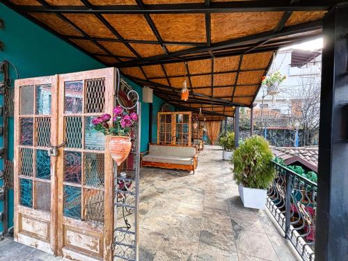 an outdoor patio with a gate and a couch at Vila Eden Boutique Hotel in Korçë