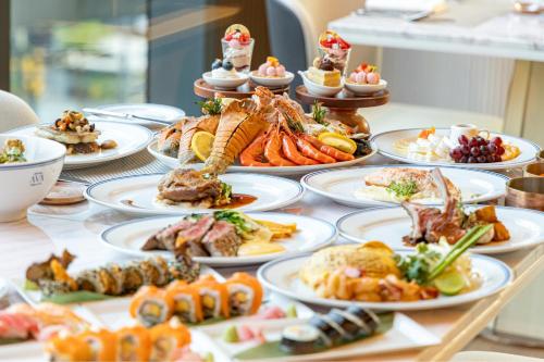 a table with many plates of food on it at InterContinental Bangkok Sukhumvit by IHG in Bangkok