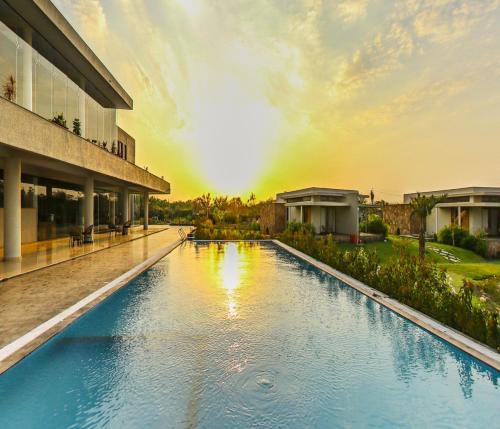 a large swimming pool in front of a building at Araiya Gir,A Mavintara Resort in Chitrāwal