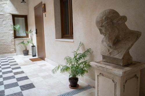 a statue of a head on a pedestal in a room at Arena Centro Rooms&Suites, by Homing U in Seville