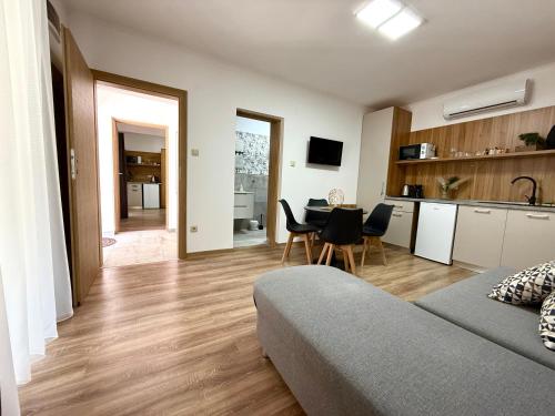 a living room with a couch and a table at Zen apartmanház Gyula in Gyula