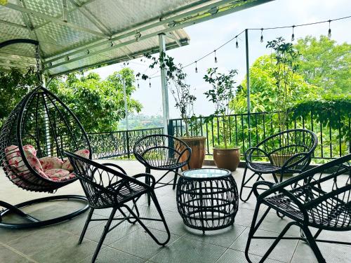 a group of chairs and a table on a patio at Tony Villa Homestay Ba Vì in Ba Vì