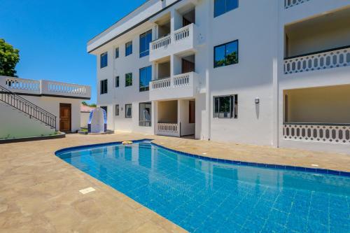 an image of a swimming pool in front of a building at Casa Nampala Diani 1 Bedroom Jungle in Diani Beach