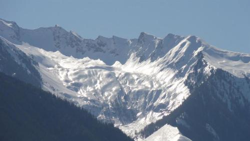 a mountain covered in snow on top at Apart Alpensonne in Zellberg