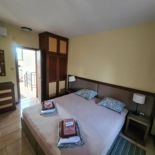 a bedroom with a bed with two trays on it at San Marco Villas in Kranevo