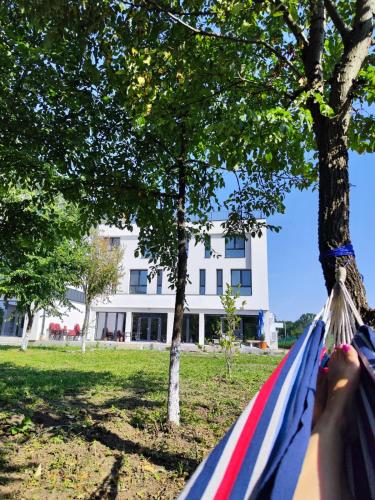 a person laying in a hammock in front of a building at INDRA WELLNESS Retreats and Spa in Samurcaşi