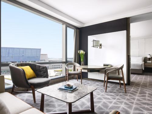 a living room with a couch and a table at Cordis Shanghai Hongqiao (Langham Hospitality Group) in Shanghai