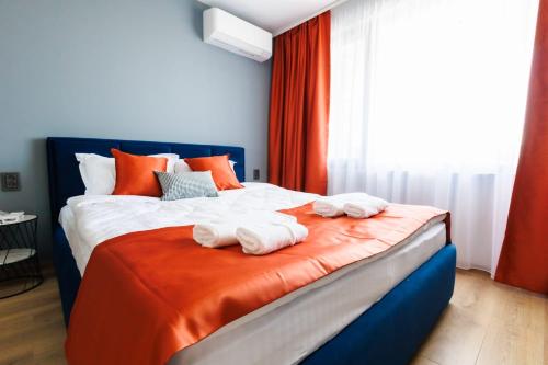 a bedroom with a bed with towels on it at Boulevard Hotel in Aytos