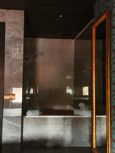 a bathroom with a glass window with a toilet at Hotel Años 50 in Torremolinos