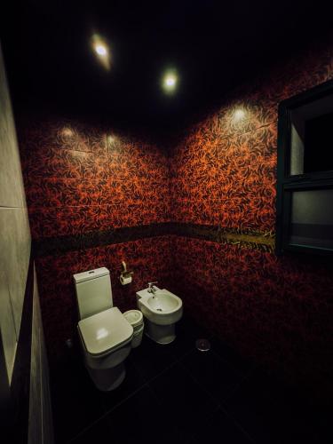 a bathroom with a toilet and a sink at Hotel Años 50 in Torremolinos