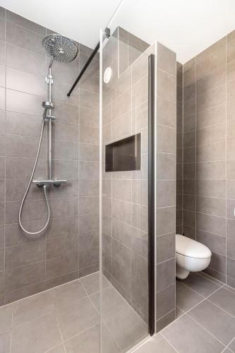 a bathroom with a shower with a toilet in it at Residence Dordrecht in Dordrecht
