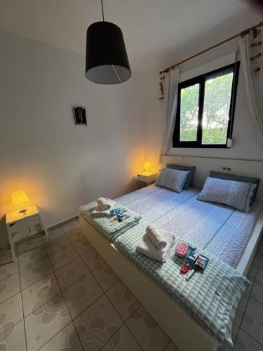a bedroom with a bed with towels on it at Sofia's house in Possidi
