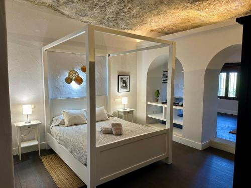 a bedroom with a bed with a large mirror at Avalon in Setenil in Setenil