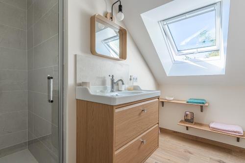 a bathroom with a sink and a shower at La Maison du Martrait - Proche de la plage in Graye-sur-Mer