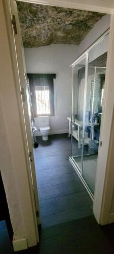 a bathroom with a toilet and a window at Avalon in Setenil in Setenil