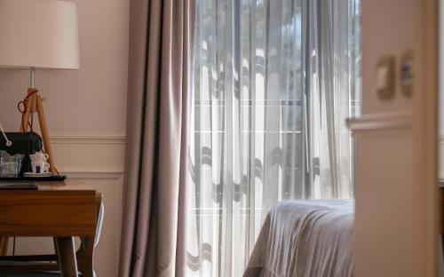 Postel nebo postele na pokoji v ubytování Hotel Majestic