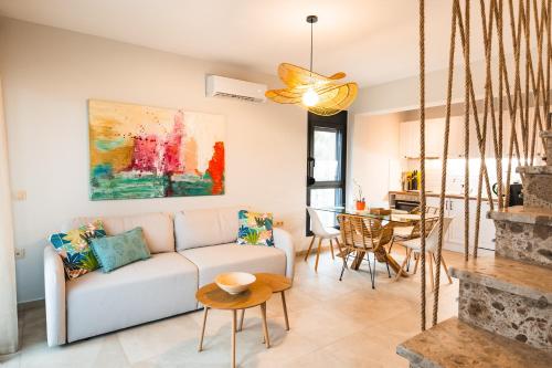 a living room with a couch and a table at Galatea Suites in Kalyves Poligirou