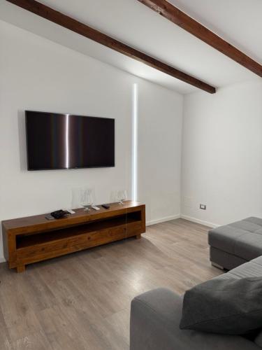 a living room with a flat screen tv on the wall at Appartamenti Venezia in Termoli