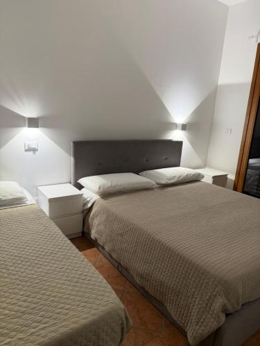 a bedroom with two beds and two night stands at Appartamenti Venezia in Termoli