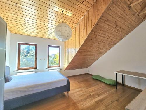 a bedroom with a bed and a wooden ceiling at Dom Nadmorski in Pierwoszyno