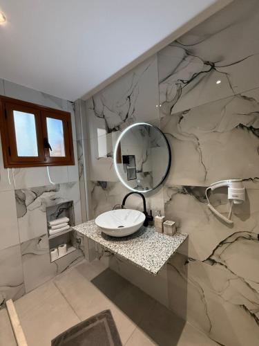 a bathroom with a sink and a mirror at Vila Dena in Vlorë